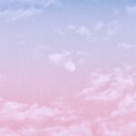 Aesthetic pastel sky with soft clouds and moon, perfect for wallpapers and backgrounds.